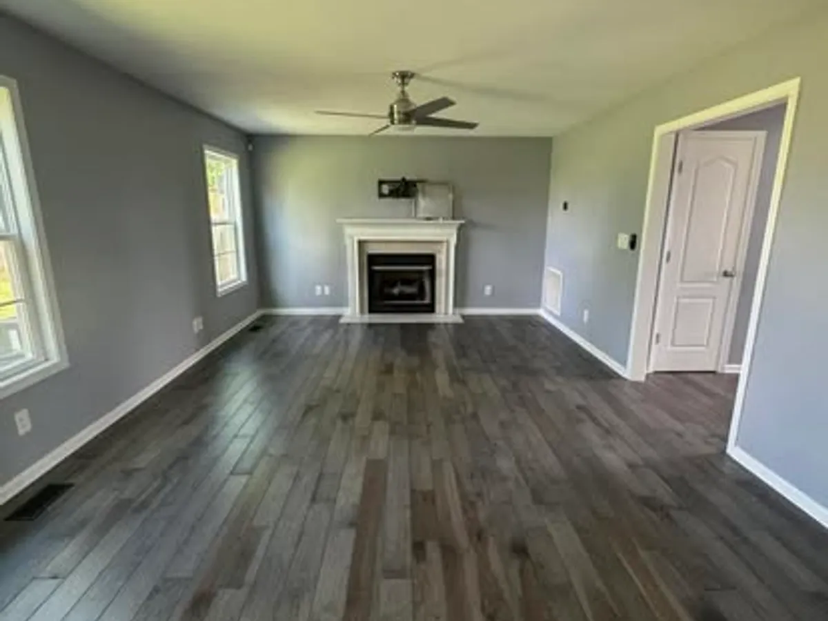 Finished custom-built great room with fireplace and hardwood floors by JM Home and Property Services in Clarksville, TN